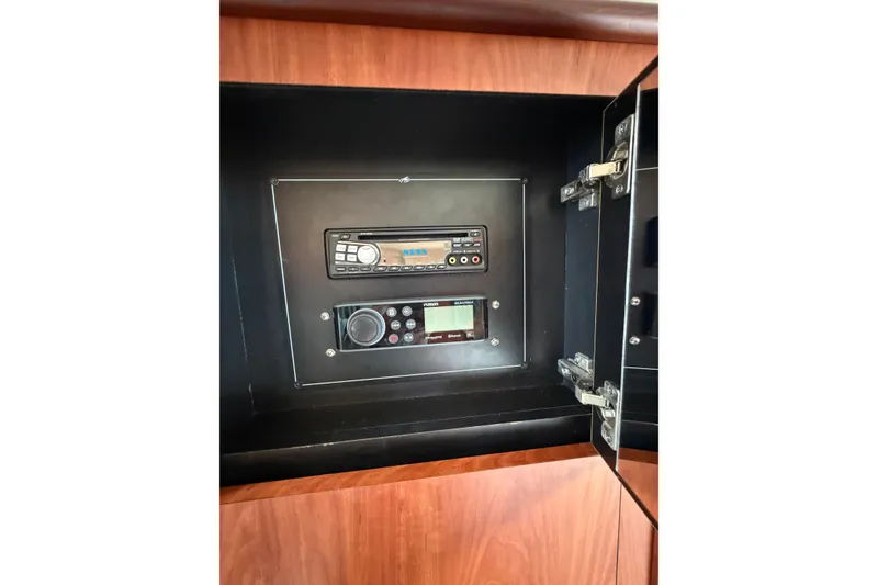 Slide: The Image of Control panel inside a 2007 Monterey 330 Sport Yacht, featuring audio and navigation systems. - 41