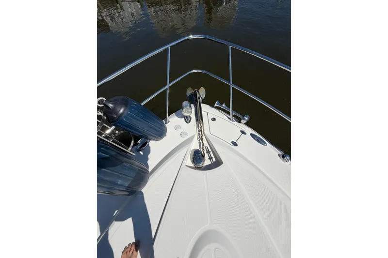 Slide: The Image of Bow view of 2007 Monterey 330 Sport Yacht with anchor and fenders on calm water. - 6
