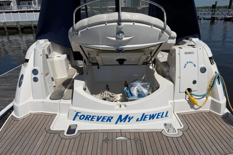 Slide: The Image of 2007 Monterey 330 Sport Yacht docked, open storage, "Forever My Jewell" on stern. - 8