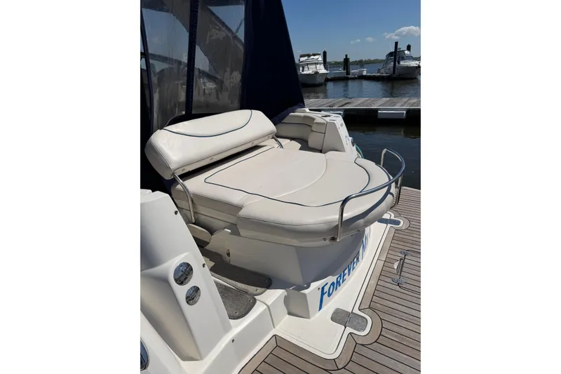 Slide: The Image of 2007 Monterey 330 Sport Yacht with cushioned seating at the dock. - 9