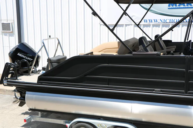 Slide: The Image of 2026 Evotti 521CS pontoon boat with Mercury engine, displayed on a trailer. - 13