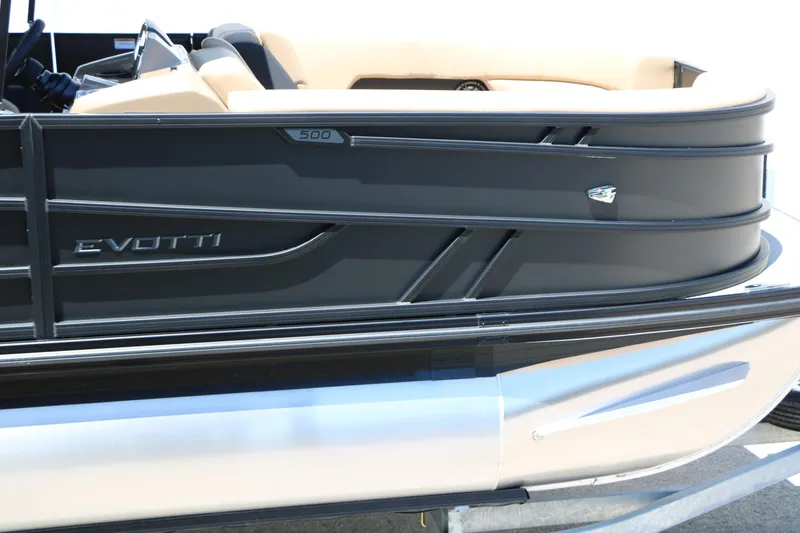 Slide: The Image of 2026 Evotti 521CS boat side view with sleek black design and beige interior. - 14