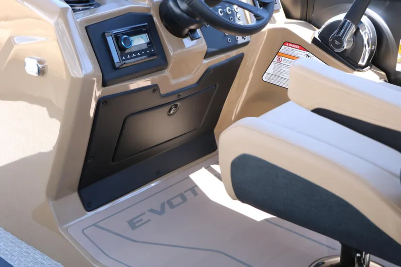 Slide: The Image of Interior of 2026 Evotti 521CS boat, featuring steering console and beige seating. - 34