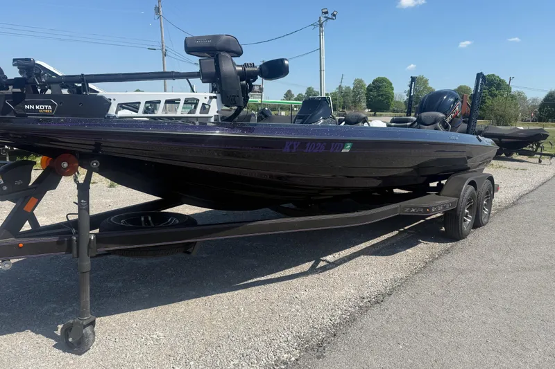 Slide: The Image of 2025 Skeeter ZXR21 boat on trailer, featuring Minn Kota Ultrex motor. - 4