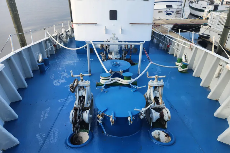 Slide: The Image of Deck view of a 1960 Stord Verft 60 ship, featuring blue-painted surface and nautical equipment. - 11