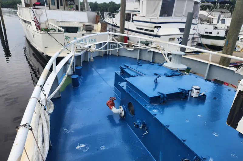 Slide: The Image of Blue deck of a 1960 Stord Verft 60 boat docked at a marina. - 21