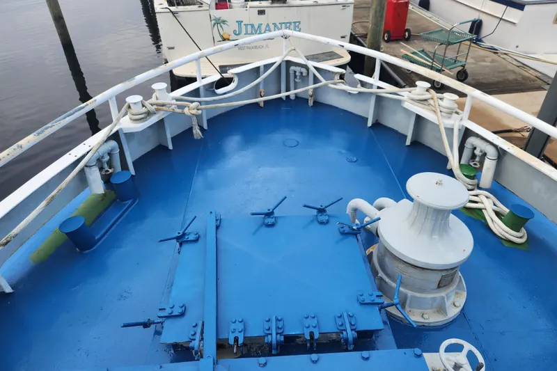 Slide: The Image of Bow of a 1960 Stord Verft 60 boat, featuring blue deck and mooring equipment. - 22