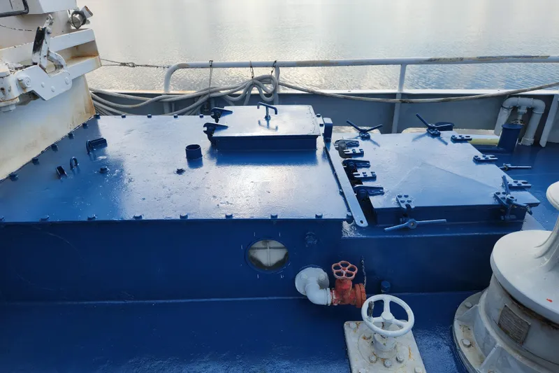 Slide: The Image of Blue deck machinery on a 1960 Stord Verft 60 vessel, featuring hatches and valves. - 27