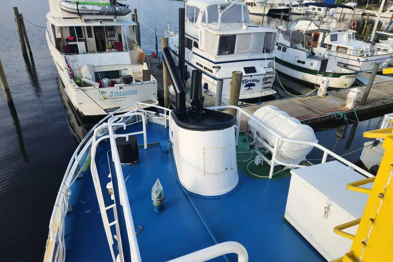 Slide: The Image of Boats docked at marina, featuring a 1960 Stord Verft model 60 vessel. - 37