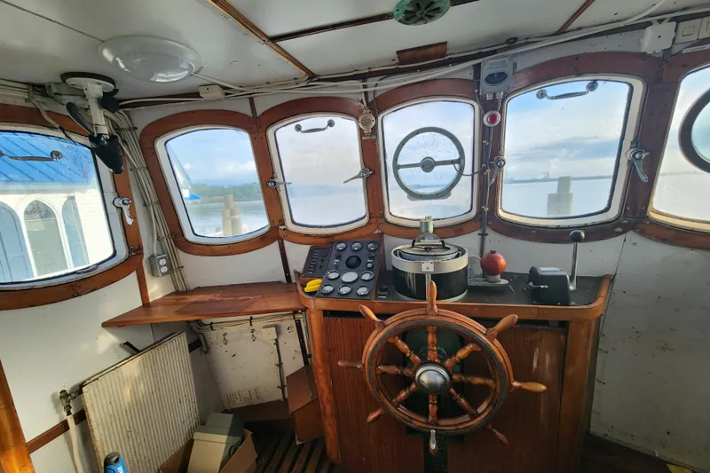 Slide: The Image of Vintage 1960 Stord Verft ship's wheelhouse with wooden steering wheel and navigational instruments. - 40