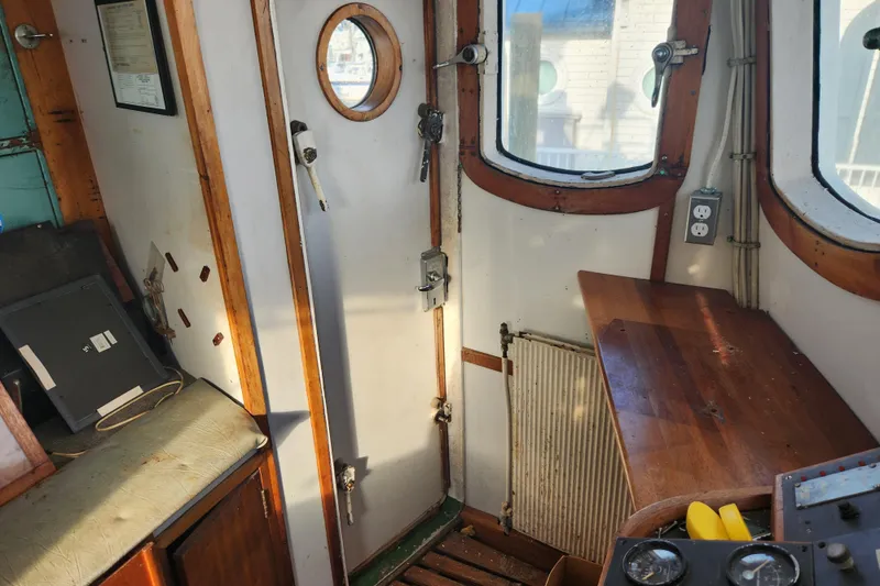 Slide: The Image of Interior of a 1960 Stord Verft 60 boat, featuring wooden accents and nautical equipment. - 47