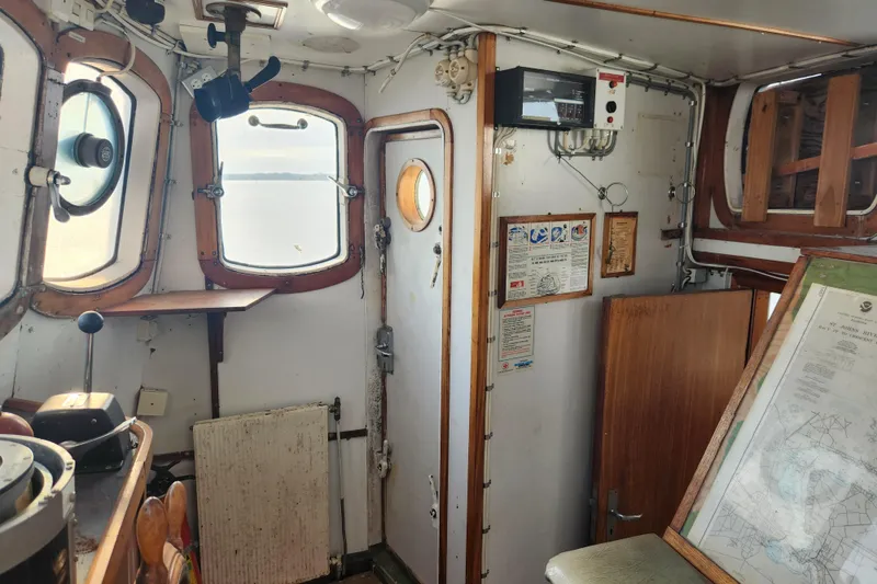 Slide: The Image of Interior of a vintage 1960 Stord Verft model 60 ship, featuring nautical equipment and maps. - 48