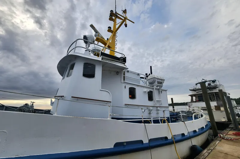 Slide: The Image of Vintage 1960 Stord Verft 60 boat docked under cloudy skies. - 5