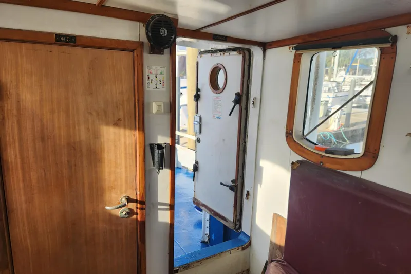 Slide: The Image of Interior of a 1960 Stord Verft 60 boat, featuring wooden and metal doors. - 55