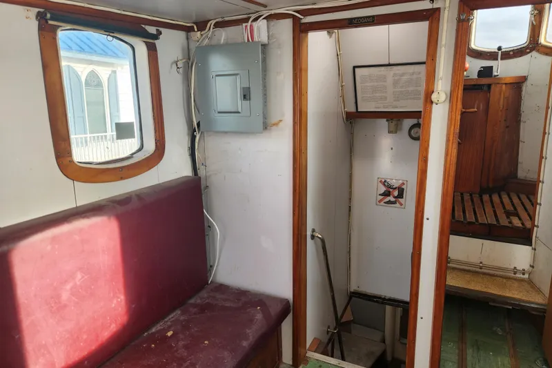 Slide: The Image of Interior of a 1960 Stord Verft 60 boat, featuring wooden trim and seating. - 57
