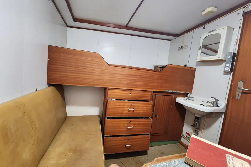 Slide: The Image of Vintage 1960 Stord Verft ship cabin interior with wooden furniture and small sink. - 59