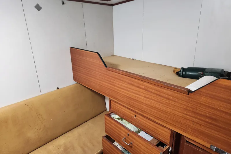 Slide: The Image of Interior of a 1960 Stord Verft 60 boat with wooden bunk and storage. - 60
