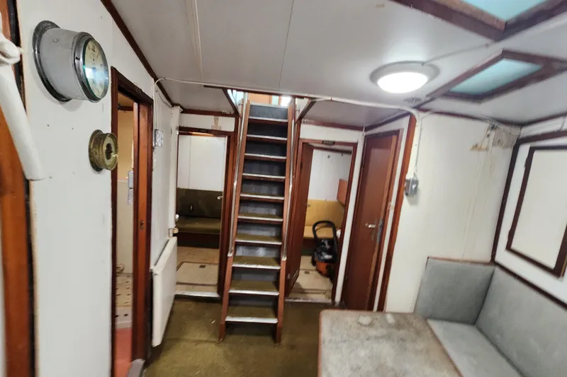 Slide: The Image of Interior of a 1960 Stord Verft model 60 ship, featuring stairs and seating area. - 69