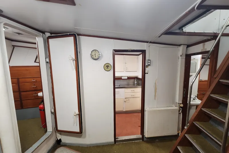 Slide: The Image of Interior of a 1960 Stord Verft model 60 ship, featuring a kitchen and stairs. - 71