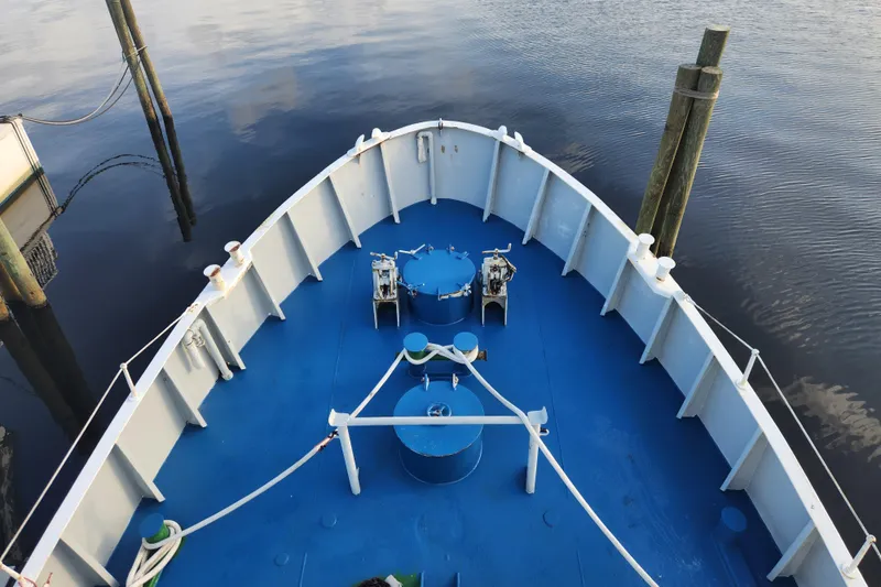 Slide: The Image of Bow of a 1960 Stord Verft 60 ship with blue deck and mooring posts. - 8