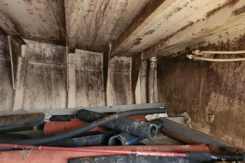 Slide: The Image of Interior of a 1960 Stord Verft 60 boat showing pipes and rusted surfaces. - 90
