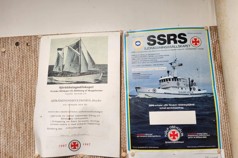 Slide: The Image of Two maritime posters featuring rescue ships and Swedish text on a bulletin board. - 94