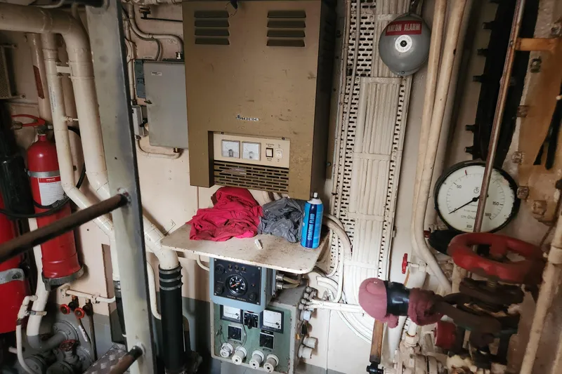 Slide: The Image of Vintage 1960 Stord Verft 60 engine room with control panel, pipes, and fire extinguisher. - 95