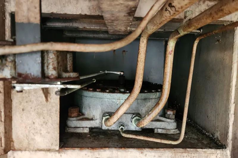 Slide: The Image of Rusty pipes and machinery inside a 1960 Vintage Stord Verft 60 engine compartment. - 98