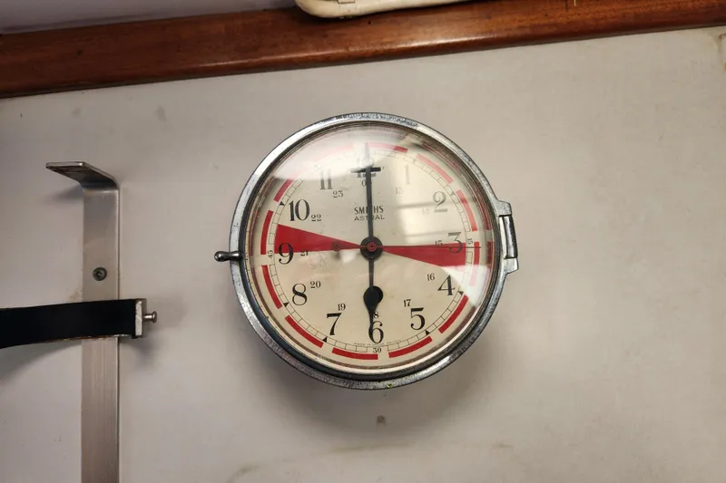 Slide: The Image of Vintage 1960 Stord Verft 60 ship clock with red and black markings on a white face. - 99