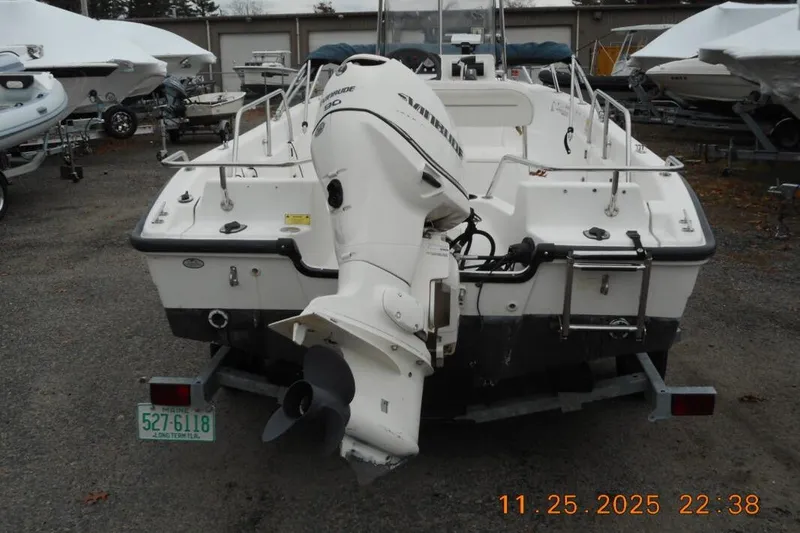 Slide: The Image of 2001 Boston Whaler 16 Dauntless boat with outboard motor, parked on trailer. - 7