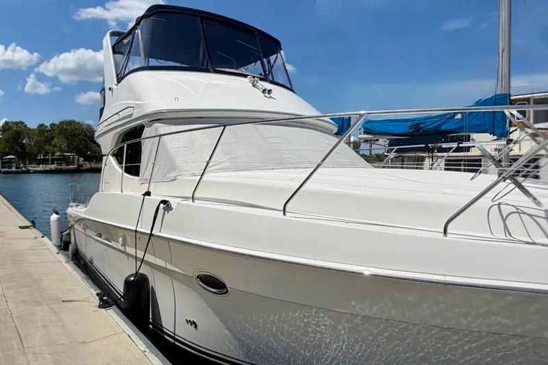 The Image of 2007 Silverton 36 Convertible yacht docked at marina under clear blue sky. - 0