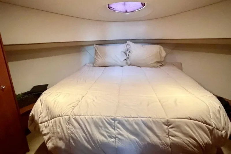 Slide: The Image of Cozy bedroom in 2007 Silverton 36 Convertible yacht with plush bedding. - 10
