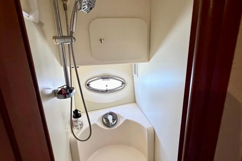 Slide: The Image of Shower area in 2007 Silverton 36 Convertible yacht with oval window and modern fixtures. - 12