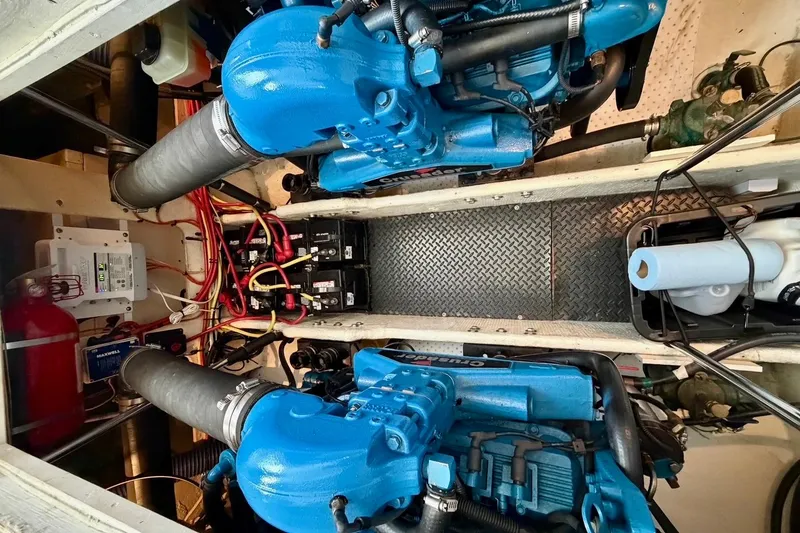 Slide: The Image of Engine room of a 2007 Silverton 36 Convertible boat with twin blue engines. - 16