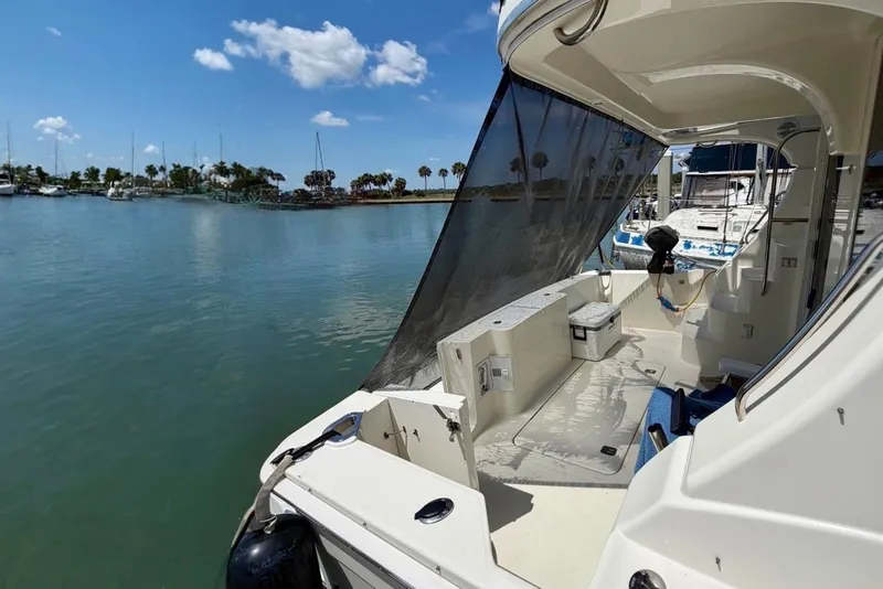 Slide: The Image of 2007 Silverton 36 Convertible yacht docked in a sunny marina with clear skies. - 2