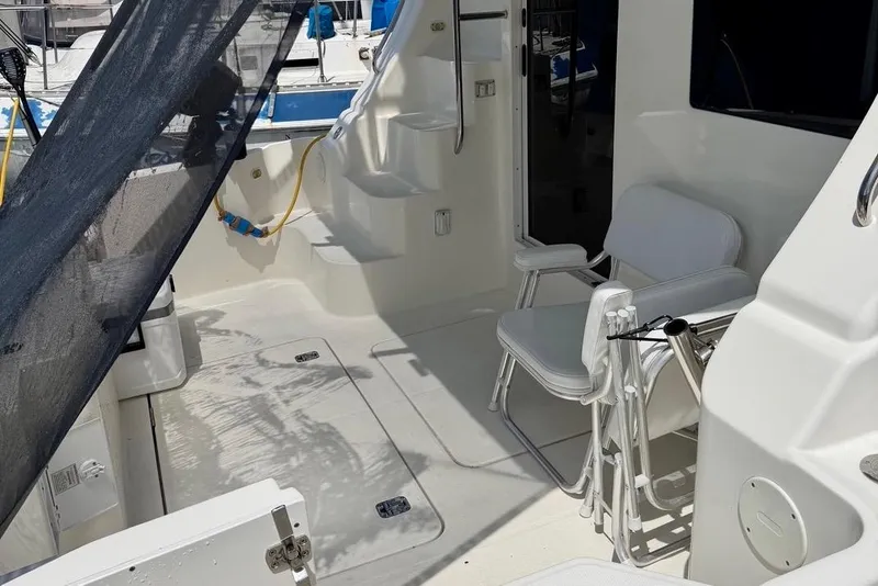 Slide: The Image of 2007 Silverton 36 Convertible yacht deck with seating and stairs. - 3