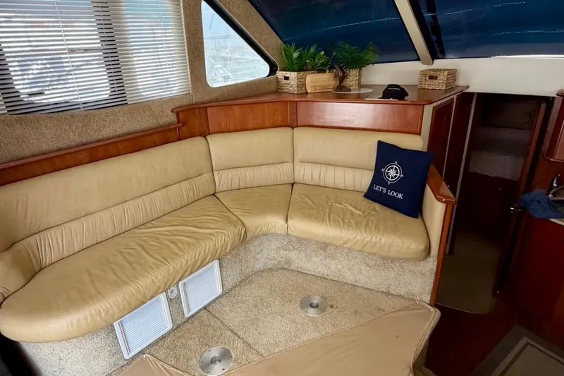 Slide: The Image of Interior of 2007 Silverton 36 Convertible yacht with beige seating and decorative pillows. - 8