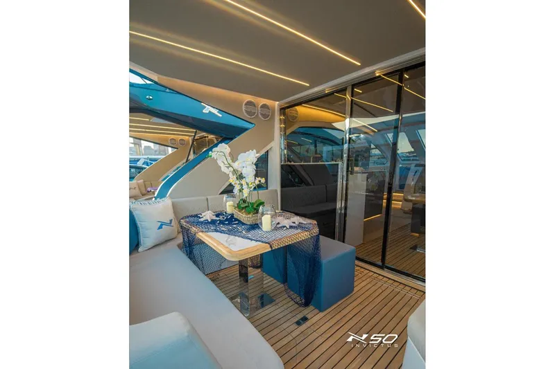 Slide: The Image of Luxurious interior of 2025 NX Boats NX50 Invictus HT with elegant seating and decor. - 10