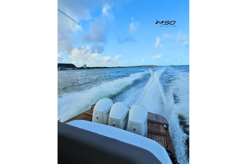 Slide: The Image of 2025 NX Boats NX50 Invictus HT cruising on open water, showcasing powerful engines and sleek design. - 17