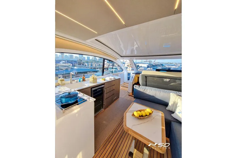 Slide: The Image of Luxurious interior of 2025 NX Boats NX50 Invictus HT yacht with modern kitchen and seating area. - 6