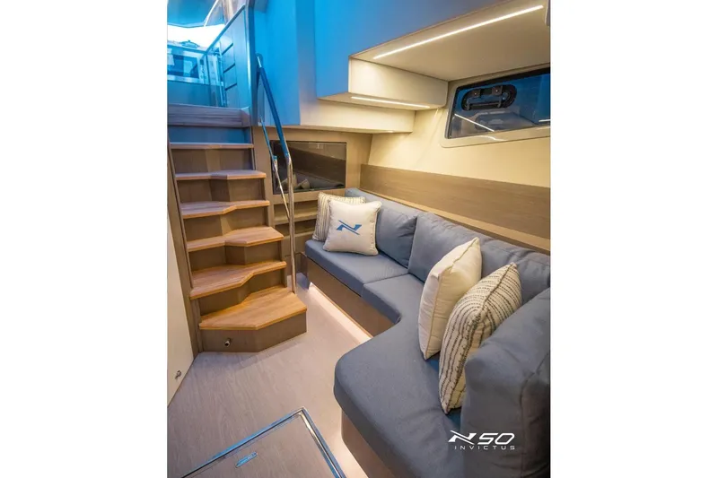 Slide: The Image of Luxurious interior of 2025 NX Boats NX50 Invictus HT with cozy seating and elegant staircase. - 8