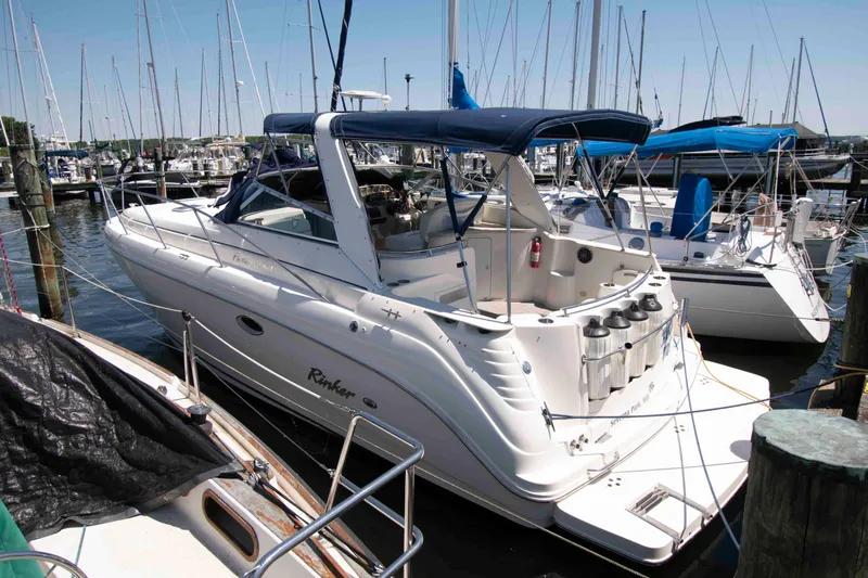 The Image of 2000 Rinker Fiesta Vee 310 boat docked at a marina with other sailboats. - 0