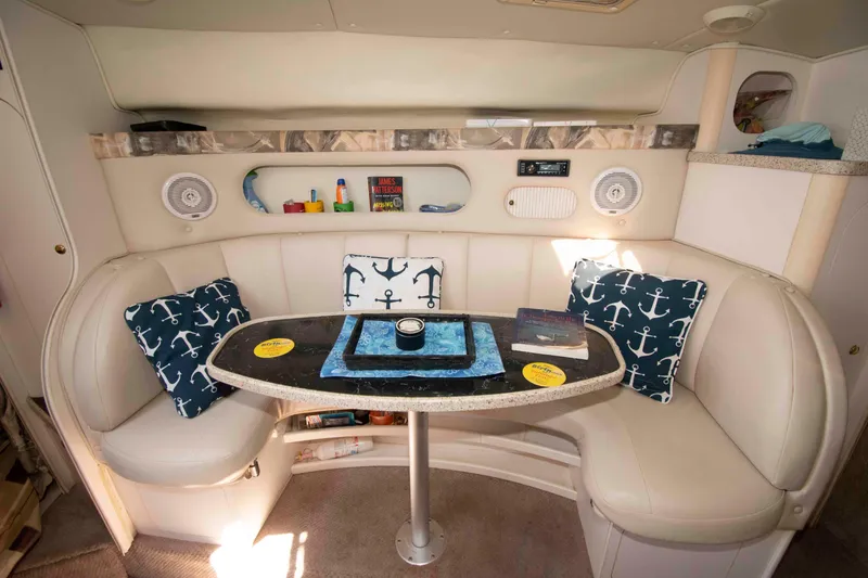 Slide: The Image of Interior of 2000 Rinker Fiesta Vee 310 with cozy seating and nautical decor. - 10