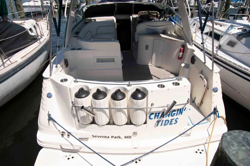 Slide: The Image of 2000 Rinker Fiesta Vee 310 boat docked, featuring open cockpit and fenders. - 2