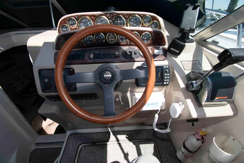Slide: The Image of Cockpit of 2000 Rinker Fiesta Vee 310 with wooden steering wheel and control panel. - 5