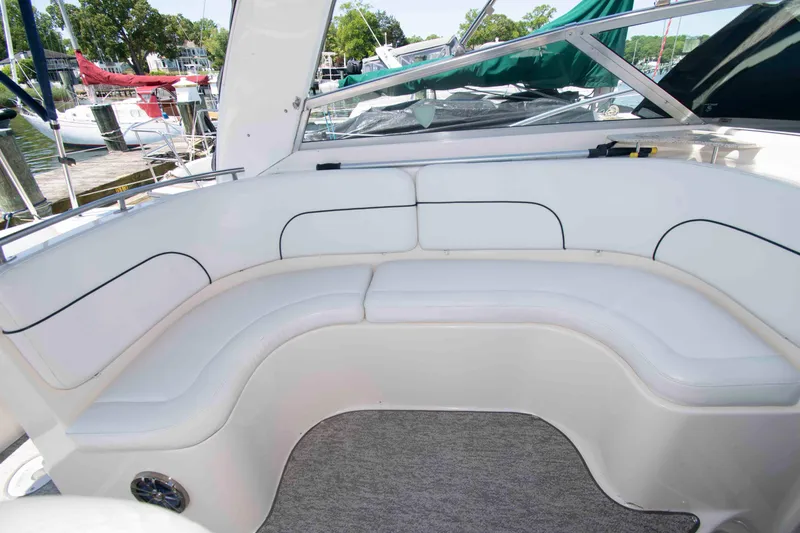 Slide: The Image of 2000 Rinker Fiesta Vee 310 boat with white cushioned seating area. - 6