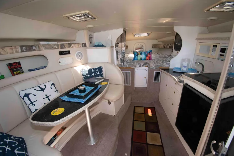 Slide: The Image of Interior of 2000 Rinker Fiesta Vee 310 boat with cozy seating and kitchenette. - 9