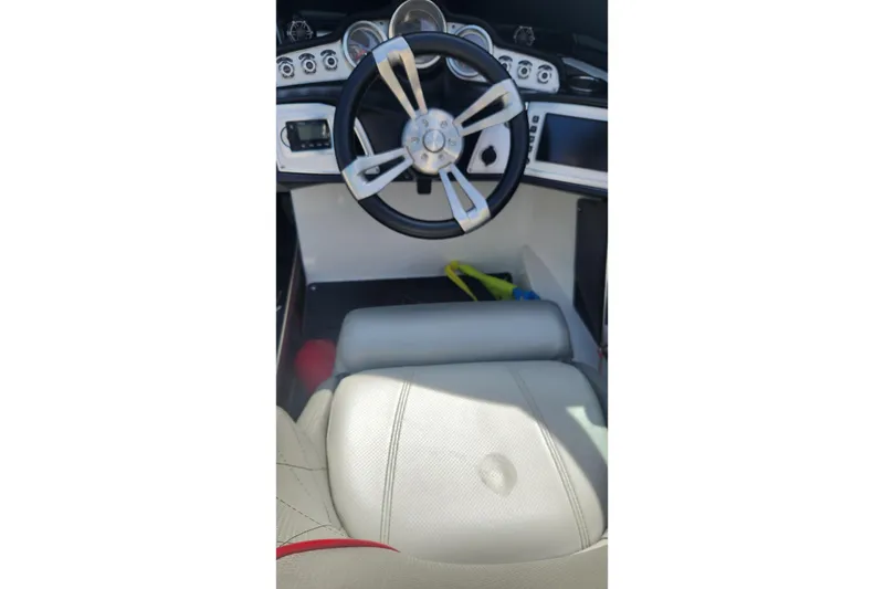 Slide: The Image of 2015 MasterCraft X23 boat interior with steering wheel and dashboard controls. - 3