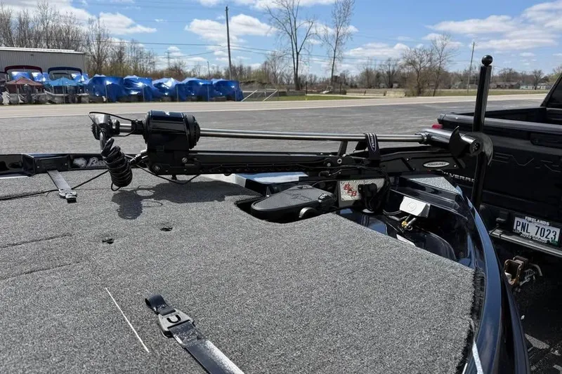 Slide: The Image of 2026 Bass Cat Jaguar STS boat deck with trolling motor, parked outdoors under a cloudy sky. - 5