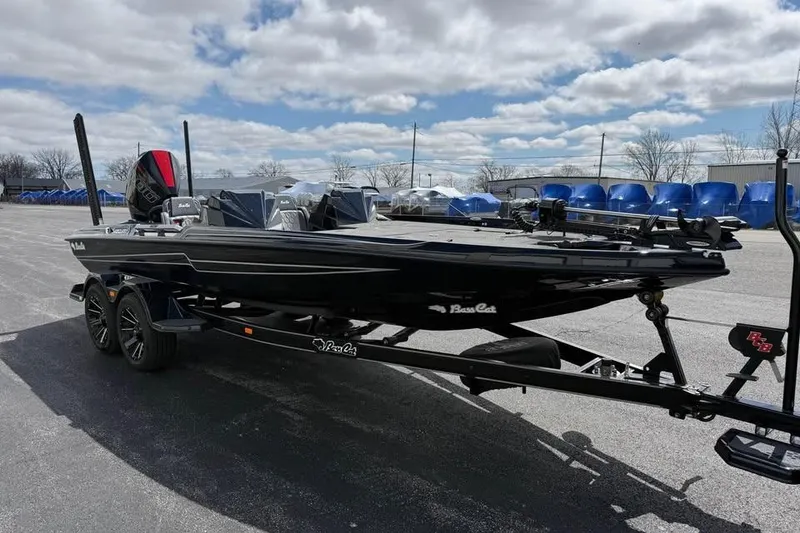 Slide: The Image of 2026 Bass Cat Jaguar STS boat on trailer under cloudy sky. - 6
